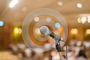 microphone in concert hall or conference room with lights in background. with extremely shallow dof