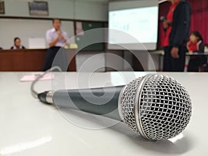 The microphone is placed on a white table. Background blur, Presentation and discussion background photo