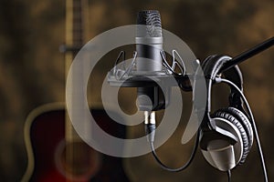 Microphone, earphones and acoustic guitar