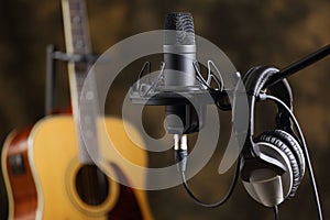 Microphone, earphones and acoustic guitar