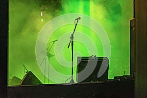 Microphone on Empty concert stage. Bright illumination, smoke. Music live performance