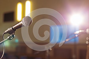 Microphone in an empty hall, the stage is prepared for the performance of musicians or a speaker