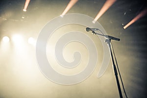 Microphone on empty stage waiting for a voice