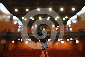 Microphone in front of an empty theatre hall