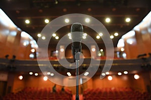 Microphone in front of an empty theatre hall