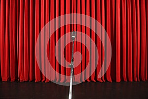 Microphone in front of a red curtain