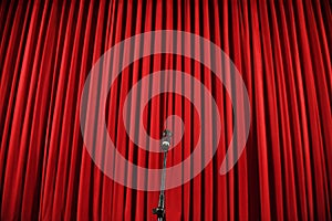 Microphone in front of a red curtain