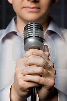 Microphone in hands of man, focus on fingers