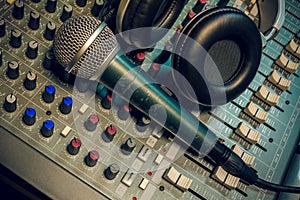 Microphone ,headphone on sound mixer background.