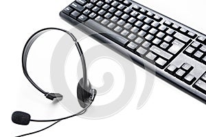 Microphone headset and computer keyboard on the table