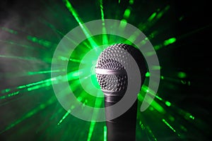 Microphone karaoke, concert . Vocal audio mic in low light with blurred background. Live music, audio equipment. Karaoke concert,