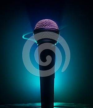 Microphone karaoke, concert . Vocal audio mic in low light with blurred background. Live music, audio equipment. Karaoke concert,