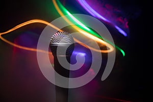 Microphone karaoke, concert . Vocal audio mic in low light with blurred background. Live music, audio equipment. Karaoke concert,