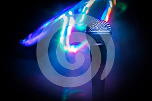 Microphone karaoke, concert . Vocal audio mic in low light with blurred background. Live music, audio equipment. Karaoke concert,