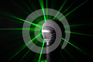 Microphone karaoke, concert . Vocal audio mic in low light with blurred background. Live music, audio equipment. Karaoke concert,