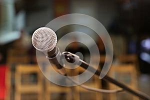 A microphone with a metal grid on the stage, will sing for the audience