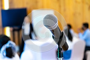 Microphone is on microphone stand in seminar meeting room for everyone to use when speaking or greeting seminar participants