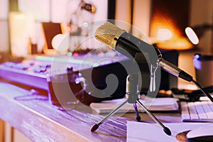 Microphone near professional mixing console on table in radio studio