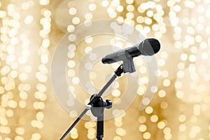 Microphone over blur gold yellow bokeh golden background beautiful romantic or luxury glitter lights circle soft pastel shade