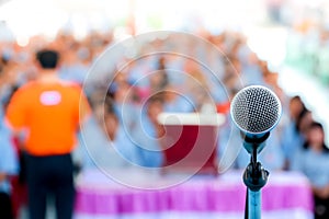 Microphone over the blurred business conference hall or seminar room, Blurred background.