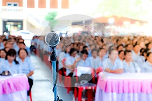 Microphone over the blurred business conference hall or seminar room, Blurred background.