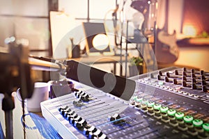 Microphone over professional mixing console on table in radio studio