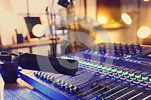 Microphone over professional mixing console on table in radio studio