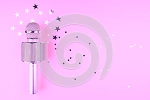 Microphone on a pink background with confetti.