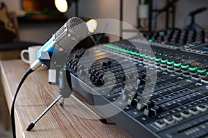 Microphone and professional mixing console on table in radio studio