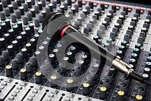 Microphone on a professional sound mixing console with adjusting