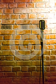 microphone ready on stage against a brick wall ready for the Karaoke performer