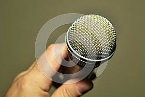 Microphone for sound amplification in a person's hand close-up