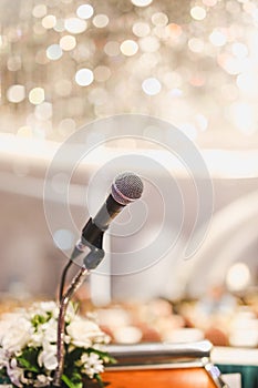 Microphone on the speech podium over the Abstract of conference