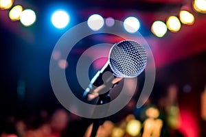 Microphone on stage against a background of auditorium.