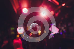 Microphone on stage against a background of auditorium.