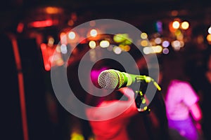 Microphone on stage against a background of auditorium.