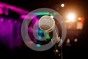 Microphone on stage against a background of auditorium