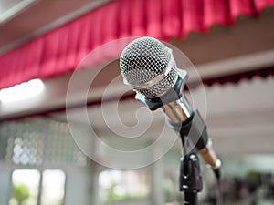 Microphone on Stage Against a Background of Auditorium.
