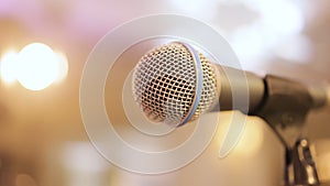 Microphone on stage against background with lighting. The silhouette of the microphone . Music instrument concept