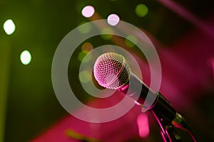 Microphone on stage with lights in background