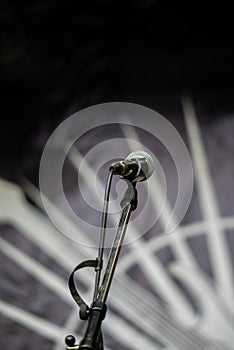 Microphone on the stand in a concert hall, close-up