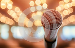 A microphone is on a stand in front of an empty auditorium