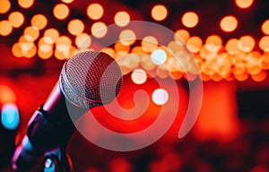 A microphone is on a stand in front of an empty auditorium