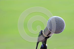 microphone stand on the grass field for announcing for outdoor sport and announcement concept design with copy space