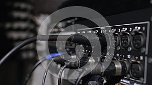 Microphone on a stand located in a music studio recording booth under low key light