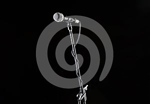 Microphone stand, microphone voice, closeup mic. Karaoke, concert, voice music. Vocal audio mic on a black background