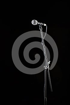 Microphone stand, microphone voice, closeup mic. Karaoke, concert, voice music. Vocal audio mic on a black background