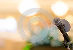 Microphone on stand at podium stage for public speaking or speech in conference hall. Mic for speaker on stage of event. Meeting