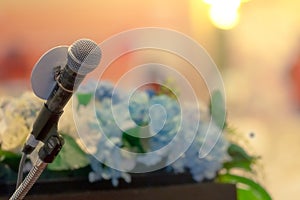 Microphone on stand at podium stage for public speaking or speech in conference hall. Mic for speaker on stage of event. Meeting