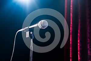 Microphone on a stand up comedy stage with reflectors ray, high contrast image